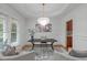 Bright office with decorative chandelier, modern furniture, and large window, perfect for a workspace at 6004 Brass Tack Ct, Fuquay Varina, NC 27526