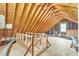An attic with exposed wooden beams, flooring and utilities, providing potential for storage or finishing at 6221 Winter Spring Dr, Wake Forest, NC 27587