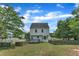 Exterior view of the rear of the house, featuring a deck and a spacious, fenced backyard at 6221 Winter Spring Dr, Wake Forest, NC 27587