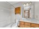 Bathroom features an oak vanity with a marble countertop and a shower-tub combination at 6221 Winter Spring Dr, Wake Forest, NC 27587