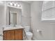 Cozy half bathroom featuring a wood vanity and decorative lighting at 6221 Winter Spring Dr, Wake Forest, NC 27587