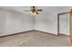 Bedroom featuring neutral walls, plush carpet, a ceiling fan, and wood trim at 6221 Winter Spring Dr, Wake Forest, NC 27587