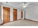 Bedroom features a ceiling fan, plush carpet, neutral walls and wood doors and trim at 6221 Winter Spring Dr, Wake Forest, NC 27587
