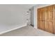 Carpeted bedroom with neutral walls and trim, wood doors and trim at 6221 Winter Spring Dr, Wake Forest, NC 27587
