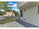 Back deck with wood railings and view of the yard, side of the house and an entry door at 6221 Winter Spring Dr, Wake Forest, NC 27587