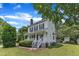 Attractive two-story home featuring a front porch, brick chimney, and well-kept lawn at 6221 Winter Spring Dr, Wake Forest, NC 27587
