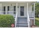 Close-up of the entrance with stairs leading up to a covered porch at 6221 Winter Spring Dr, Wake Forest, NC 27587