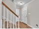 Bright entryway with hardwood floors and a staircase with a wooden handrail at 6221 Winter Spring Dr, Wake Forest, NC 27587