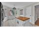 Kitchen island provides extra counter space, enhanced by a stained-glass light fixture at 6221 Winter Spring Dr, Wake Forest, NC 27587