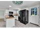 Bright kitchen features white cabinets, butcher block island, and black appliances with backyard views at 6221 Winter Spring Dr, Wake Forest, NC 27587