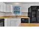 Bright kitchen space with a window over the sink and modern black appliances at 6221 Winter Spring Dr, Wake Forest, NC 27587