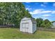 Exterior of a white backyard storage shed with a double door and mature trees at 6221 Winter Spring Dr, Wake Forest, NC 27587