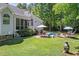 Backyard featuring a swimming pool, a screened porch, and lots of green grass and mature trees at 65 Georgetown Woods Dr, Youngsville, NC 27596