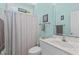 Bathroom with blue walls, shower with curtain, and large mirror at 65 Georgetown Woods Dr, Youngsville, NC 27596