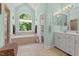 Bright bathroom featuring a soaking tub, double vanity, and ample natural light at 65 Georgetown Woods Dr, Youngsville, NC 27596