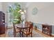 Dining room showcasing a large window, elegant chandelier, and decorative tree wall art at 65 Georgetown Woods Dr, Youngsville, NC 27596