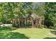 Charming brick home featuring a well-manicured lawn and lush landscaping at 65 Georgetown Woods Dr, Youngsville, NC 27596