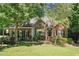 Charming brick home featuring a well-manicured lawn and lush landscaping at 65 Georgetown Woods Dr, Youngsville, NC 27596