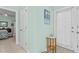Inviting hallway with fresh paint, tile flooring, and natural light streaming through the sheer-curtained door at 65 Georgetown Woods Dr, Youngsville, NC 27596
