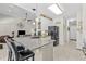 Open-concept kitchen with island seating, granite countertops, and stainless steel appliances at 65 Georgetown Woods Dr, Youngsville, NC 27596