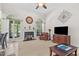 Comfortable living room with a fireplace, arched windows, and a ceiling fan at 65 Georgetown Woods Dr, Youngsville, NC 27596