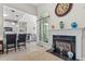 Inviting space featuring tile flooring, fireplace, arched windows and eat-in bar to kitchen at 65 Georgetown Woods Dr, Youngsville, NC 27596