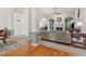 Bright living room featuring hardwood floors, elegant columns, a cozy fireplace, and large arched windows at 65 Georgetown Woods Dr, Youngsville, NC 27596