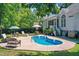 Inviting private pool with a concrete deck surrounded by mature trees at 65 Georgetown Woods Dr, Youngsville, NC 27596