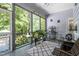 Relaxing screened porch with comfortable seating and peaceful views of the backyard greenery at 65 Georgetown Woods Dr, Youngsville, NC 27596