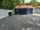 Spacious gravel backyard with white fence providing ample parking and outdoor space at 713 Champion St, Henderson, NC 27536