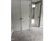 Hallway with carpet and closet with double doors at 713 Champion St, Henderson, NC 27536