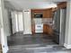 The kitchen is freshly painted with wood cabinets and a stainless steel refrigerator at 713 Champion St, Henderson, NC 27536