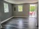 Bright room showcasing vinyl floors, fresh paint and windows providing ample natural light at 713 Champion St, Henderson, NC 27536