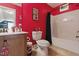 Bathroom with a red accent wall and shower/tub combination at 732 Keystone Park Dr, Morrisville, NC 27560