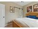 This cozy bedroom boasts a queen size bed and barn style closet door at 732 Keystone Park Dr, Morrisville, NC 27560