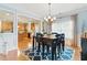 Eat-in dining room shows chair-height table, chandelier, wood floors, and access to kitchen space at 732 Keystone Park Dr, Morrisville, NC 27560