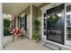 Welcoming front porch with seating, attractive landscaping, and a charming front door at 732 Keystone Park Dr, Morrisville, NC 27560