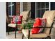 Close-up of comfortable seating on the front porch with decorative pillows and charming details at 732 Keystone Park Dr, Morrisville, NC 27560