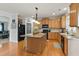 Spacious kitchen featuring a central island, stainless steel appliances, and wood flooring at 732 Keystone Park Dr, Morrisville, NC 27560