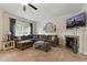Cozy living room featuring plush seating, a fireplace, and natural light at 732 Keystone Park Dr, Morrisville, NC 27560