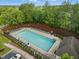 Aerial view of community pool with lounge chairs surrounded by lush landscaping and trees at 732 Keystone Park Dr, Morrisville, NC 27560