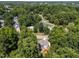 Overhead view of a neighborhood, with homes tucked among mature trees and winding roads in a serene, residential area at 7605 Pats Branch Dr, Raleigh, NC 27612
