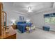 Spacious bedroom offers a tray ceiling, large window, sitting bench, and gray carpet at 7605 Pats Branch Dr, Raleigh, NC 27612