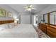 Comfortable bedroom with carpet, wooden furniture, closet and ceiling fan at 7605 Pats Branch Dr, Raleigh, NC 27612