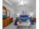 Bedroom features a large bed, wooden dresser, sitting bench and gray carpet at 7605 Pats Branch Dr, Raleigh, NC 27612