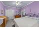 Serene bedroom with lavender walls, neutral carpet, and comfortable furnishings at 7605 Pats Branch Dr, Raleigh, NC 27612