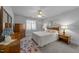 Cozy bedroom with neutral tones, carpet, wooden furniture and ceiling fan at 7605 Pats Branch Dr, Raleigh, NC 27612