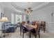 Formal dining room featuring a modern chandelier, a large window, and dark wood furniture at 7605 Pats Branch Dr, Raleigh, NC 27612