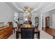 Elegant dining room with a modern chandelier, comfortable seating, and a view of the living area at 7605 Pats Branch Dr, Raleigh, NC 27612
