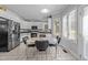 Eat-in kitchen with sleek, white cabinets, stainless steel appliances, and a retro-style dining set at 7605 Pats Branch Dr, Raleigh, NC 27612